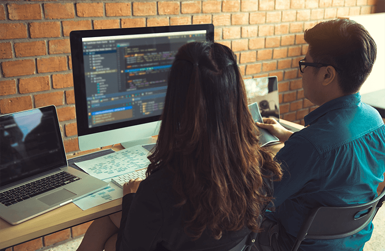 Woman and man in front of a computer